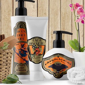 May include: Three bottles of liquid soap with Halloween-themed labels. The labels feature witches, bats, and the text "Moon Light Side", "Lady Macbeth Vanishing Creme", and "Midnight Bouquet for Discerning Witches". A white orchid plant in a white pot and a white towel are also in the image.
