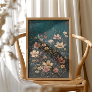May include: A framed floral print featuring a variety of flowers in shades of pink, yellow, and purple against a dark teal background. The artwork is displayed on a wooden chair, with a white curtain in the background.