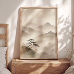 May include: A vertical rectangular wall art print in a light wooden frame featuring a landscape painting of layered mountain ranges fading into a soft, misty fog with a prominent, gnarled pine tree perched on a rocky cliff in the foreground.