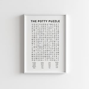 May include: A framed print titled "THE POTTY PUZZLE" features a word search grid with related words like "flush" and "pee." The print is in black and white, with a white border.