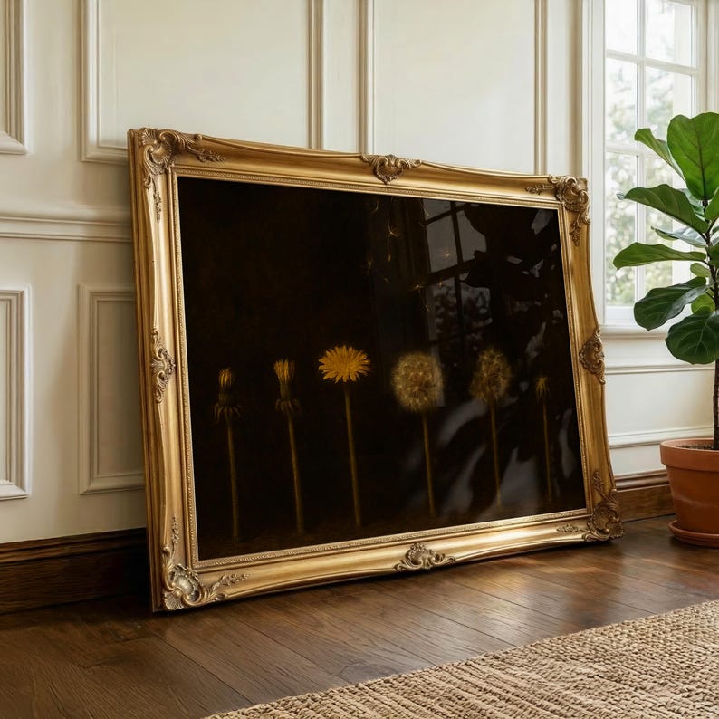 May include: A large, ornate gold framed artwork featuring a dark background with a series of dandelion seed heads in various stages of development. The artwork is leaning against a wall and floor, with a plant in a terracotta pot visible.