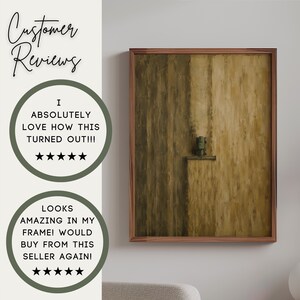 May include: A framed vertical wall art piece featuring an abstract composition in shades of brown and tan. The artwork displays a textured, vertical brushstroke pattern with a small, dark, rectangular element centered on a horizontal ledge.