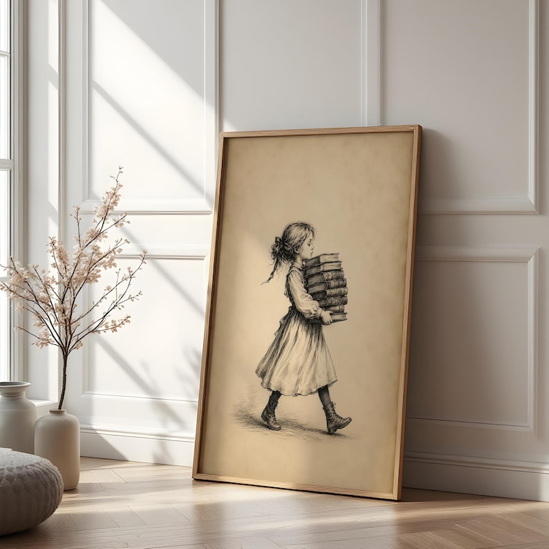 May include: A framed wall art print featuring a black and white pencil sketch of a young person with long hair tied back, wearing a dress and boots, walking while carrying a tall stack of thick books in their arms against a plain background.