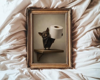 May include: A framed wall art print featuring a small, dark-furred bat standing on a wooden shelf. The bat is holding a white roll of toilet paper with both hands. The artwork is enclosed in an ornate, metallic gold-colored rectangular frame.
