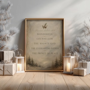 May include: A framed wall art print featuring the text His name shall be called WONDERFUL COUNSELLOR THE MIGHTY GOD THE EVERLASTING FATHER THE PRINCE OF PEACE ISAIAH 9:6 with a pine branch illustration above and a forest scene below.