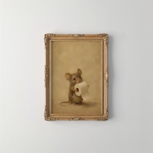 May include: A framed oil painting featuring a small brown mouse holding a roll of white toilet paper. The artwork is set against a solid beige background and is enclosed in an ornate, decorative gold-colored frame with intricate carved details.