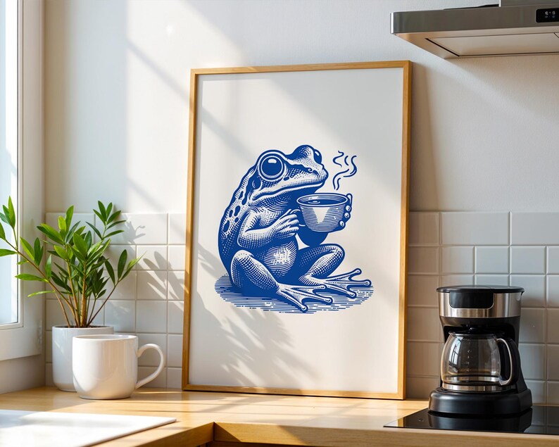 May include: A blue and white illustration of a frog holding a cup of coffee. The frog is sitting on a green leaf and there is steam coming from the cup.