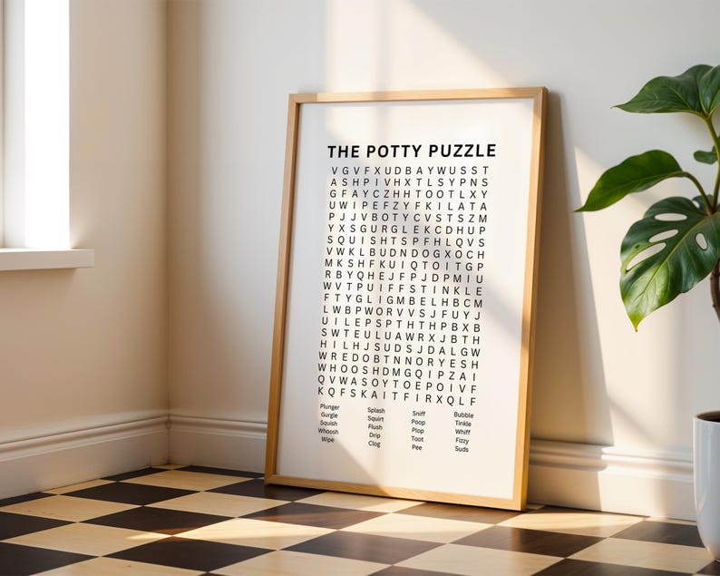 May include: A framed wall art print titled THE POTTY PUZZLE featuring a word search grid with black letters on a white background. Below the grid, a list of words including Plunger, Gurgle, Squish, Whoosh, Wipe, Splash, Squirt, Flush, Drip, Clog, Sniff, Poop, Plop, Toot, Pee, Bubble, Tinkle, Whiff, Fizzy, and Suds.