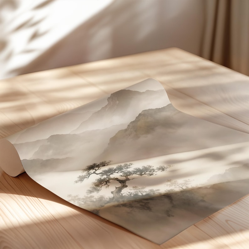 May include: A roll of wallpaper featuring a monochromatic landscape illustration in shades of beige, cream, and soft gray. The design depicts a misty mountain range with a prominent gnarled tree in the foreground, rendered in a traditional ink wash style.