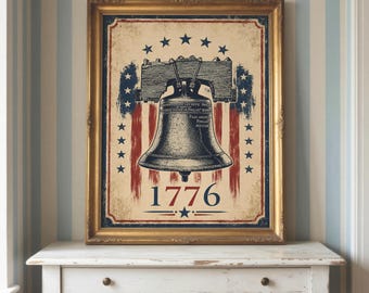 May include: Framed print featuring the Liberty Bell, stars, and stripes in red, white, and blue. The year "1776" is displayed below the bell. The print is in a gold-colored frame, evoking a vintage aesthetic.