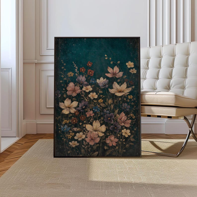 May include: A framed floral print featuring a variety of flowers in shades of pink, purple, and cream against a dark teal background. The artwork is displayed in a room with a neutral-toned rug and a white chair.