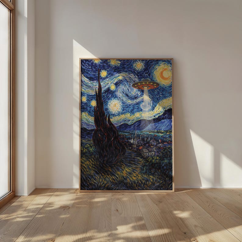 May include: Framed print of a reimagined "Starry Night" painting. The artwork features a swirling night sky with a UFO beaming light down on a village. The print is in a wooden frame and leans against a white wall.