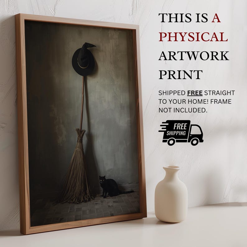 May include: A framed artwork print featuring a black witch hat hanging above a broomstick with a black cat sitting on the floor. The text reads: THIS IS A PHYSICAL ARTWORK PRINT SHIPPED FREE STRAIGHT TO YOUR HOME! FRAME NOT INCLUDED. FREE SHIPPING.