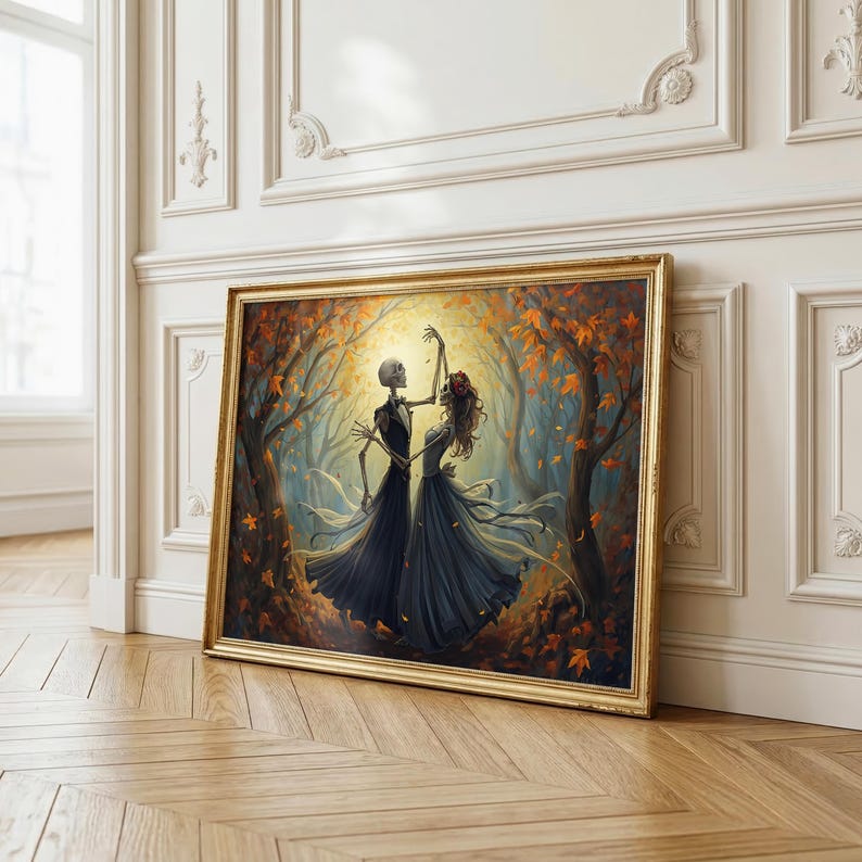 May include: A framed wall art print depicting two skeletons dancing in a forest filled with orange and yellow autumn leaves. The figures wear dark, flowing attire, with one skeleton adorned with a red floral headpiece, set against a glowing light.