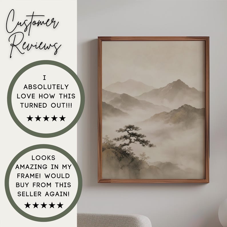 May include: A framed wall art print featuring a monochromatic landscape of misty mountains and a lone pine tree in the foreground. The artwork is displayed in a thin brown wooden frame. The text Customer Reviews appears above two circular badges.
