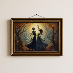 May include: A framed wall art print depicting two skeletons dancing in a forest filled with autumn leaves. One skeleton wears a dark suit and the other wears a long dark dress with a red floral headpiece. The scene is illuminated by a bright light.