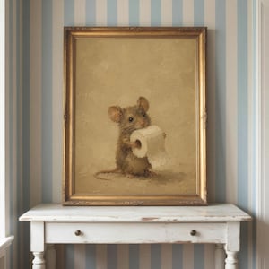May include: A framed oil painting featuring a brown mouse holding a roll of white toilet paper. The artwork is rendered in a textured, painterly style with a neutral beige background, enclosed within an ornate, metallic gold-toned rectangular frame.