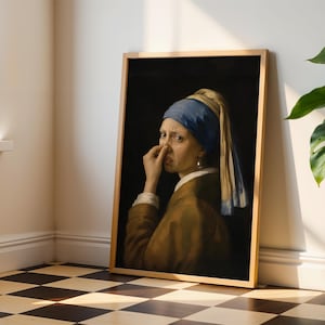 May include: A framed art print featuring a parody of the Girl with a Pearl Earring, depicting a person wearing a blue headscarf and brown jacket, holding their nose with a disgusted expression against a dark background.