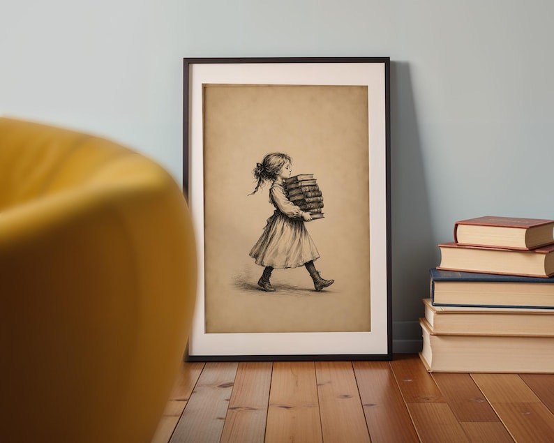 May include: A framed wall art print featuring a sepia-toned illustration of a person with braided hair wearing a dress and boots, walking while carrying a tall stack of books. The artwork is displayed in a simple black frame on a wooden floor.