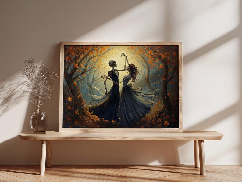 May include: A rectangular framed wall art print featuring an illustration of two skeletons dancing in a forest filled with autumn leaves. The skeletons are dressed in formal attire, with one wearing a dark suit and the other a dark flowing gown.