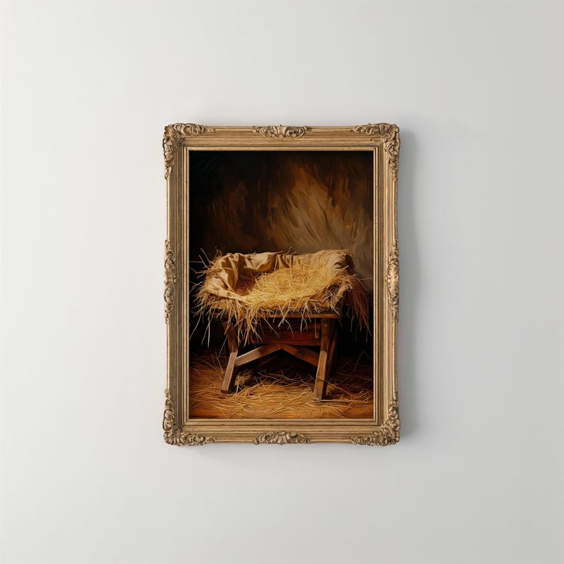 May include: A framed painting depicts a wooden manger filled with straw, covered by a tan cloth. The manger is set against a dark, textured background, with a golden ornate frame. The artwork evokes a sense of warmth and reverence.