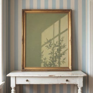 May include: A rectangular wall art piece featuring a sage green background with a shadow of a leafy plant cast across it, encased in an ornate, antique-style gold frame with intricate carved detailing along the edges and corners.
