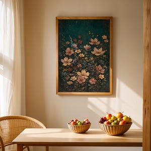 May include: A framed floral print with a wooden frame hangs above a wooden table. Two woven baskets hold fruit. A wicker chair sits near a sheer curtain. The artwork features a variety of flowers in shades of pink, white, and purple against a dark green background.