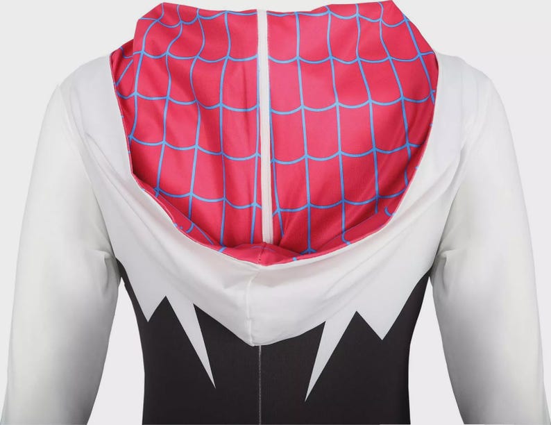 May include: A long-sleeved hooded garment featuring a white upper section and a black lower section with jagged white accents. The hood interior is bright pink with a blue web pattern, and the hood features a central white vertical seam detail.