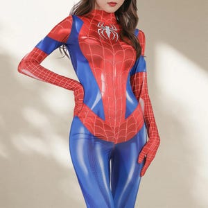 May include: A red, blue, and white Spider-Man costume. The full-body suit features a red spiderweb design on the chest and arms, with a white spider emblem. The costume has a high neckline and long sleeves.