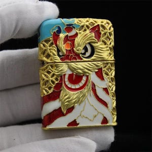 Luxury Gold Enamel Zippo Lighter – Collectible Art with Mythical Creature Design