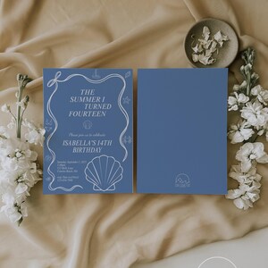 May include: Blue birthday invitation with white text and seashell illustrations. The text reads "The Summer I Turned Fourteen" and "Isabella's 14th Birthday." The invitation is accompanied by a blank blue card. The design includes a nautical theme.
