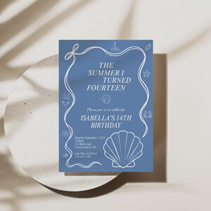 May include: A blue invitation card with white text and illustrations for a 14th birthday. The card features a seashell, starfish, and other nautical-themed designs. The text reads "The Summer I Turned Fourteen" and "Isabella's 14th Birthday."