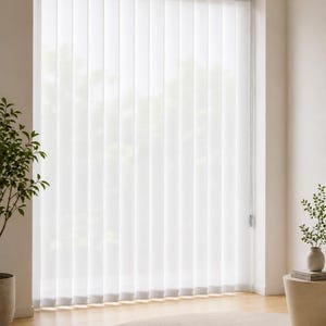 May include: White vertical blinds covering a large window, featuring long, slender fabric slats that hang from a top track. The translucent material allows soft, diffused light to filter through, creating a clean and uniform appearance across the window.