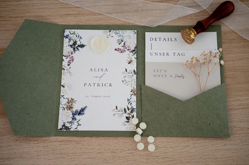 May include: An open olive green wedding invitation suite with floral accents. The invitation features the names "ALISA and PATRICK" and the date "19. August 2026". A wax seal, a stamp, and additional cards are included.