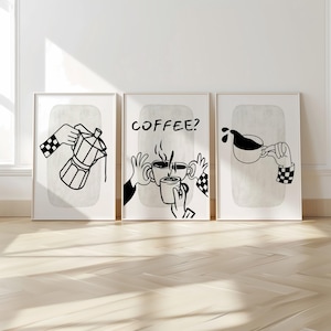 May include: Set of three framed art prints with minimalist coffee-themed illustrations in black and white. One shows a coffee maker, another asks "Coffee?", and the third depicts coffee pouring into a cup. Each print features a neutral background.