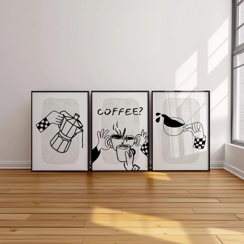 May include: Set of three framed black and white coffee-themed art prints. Each print features a different coffee-related illustration: a coffee maker, the word "COFFEE?" with coffee cups, and coffee pouring into a cup. The hands in the illustrations have checkered sleeves.