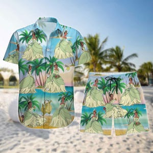 May include: A matching button-down shirt and shorts set featuring a repeating pattern of a princess in a green gown, palm trees, and a beach scene. The shirt has short sleeves, and the shorts have a drawstring waist. The set is in shades of blue, green, and tan.