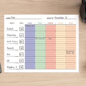 May include: A weekly planner with a light blue, green, orange, and yellow color scheme. The planner is labeled "Week of: November 11". The planner has columns for Monday, Tuesday, Wednesday, Thursday, and Friday. Each column has lines for writing in assignments and notes. The planner also has a section for subject, grade, and assignments due.