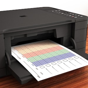 May include: A black inkjet printer with a sheet of paper coming out of the paper tray. The paper has a colorful chart with checkboxes and lines.