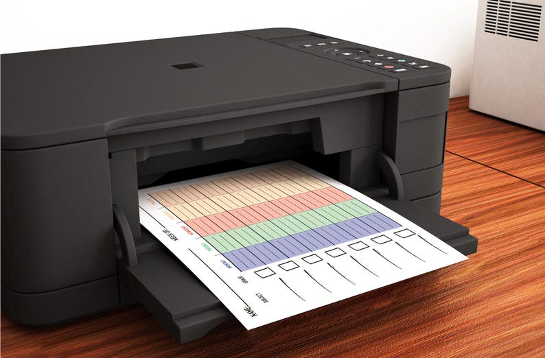 May include: A black inkjet printer with a sheet of paper coming out of the paper tray. The paper has a colorful chart with checkboxes and lines.