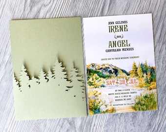 May include: Wedding invitation with a green forest silhouette on the front and a watercolor landscape with the text "ANN GELINAS IRENE AND ANGEL CARVALHO MENDES" on the back. The invitation states "INVITE YOU TO THEIR WEDDING CEREMONY SAT 28 JUL AT TWO O'CLOCK WHITE HOUSE WEDDING CHAPEL 4360 E 13 MILE RD WARREN, MI 48092 RECEPTION TO FOLLOW."
