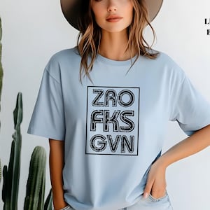 May include: A light blue t-shirt with a black graphic that says "ZRO FKS GVN".