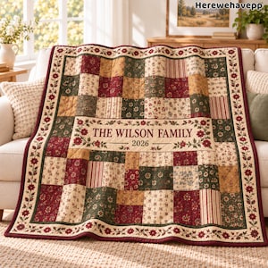May include: A patchwork quilt featuring a variety of floral and striped fabric squares in shades of burgundy, forest green, and cream. The center panel displays the text THE WILSON FAMILY and the year 2026, surrounded by a floral vine border.