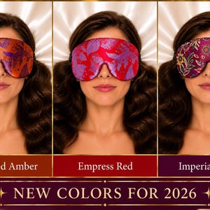 May include: Three sleep masks featuring floral patterns in Burnished Amber, Empress Red, and Imperial Plum. Each mask has a contoured shape and an elastic strap. The text at the bottom reads NEW COLORS FOR 2026, with labels for each color variant.