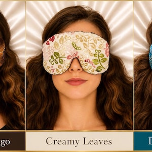 May include: Three sleep masks featuring distinct patterns: a chocolate brown mask with gold ginkgo leaf embroidery, a cream-colored mask with multi-colored floral leaf embroidery, and a dark turquoise mask with a swirling blue and silver leaf pattern.