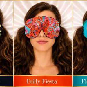 May include: Three sleep masks featuring distinct patterns: a black mask with dragonfly motifs labeled Dragonfly Nite, a vibrant red mask with intricate multi-colored floral designs labeled Frilly Fiesta, and a turquoise mask with large pink and white floral prints labeled Floral Turquoise.
