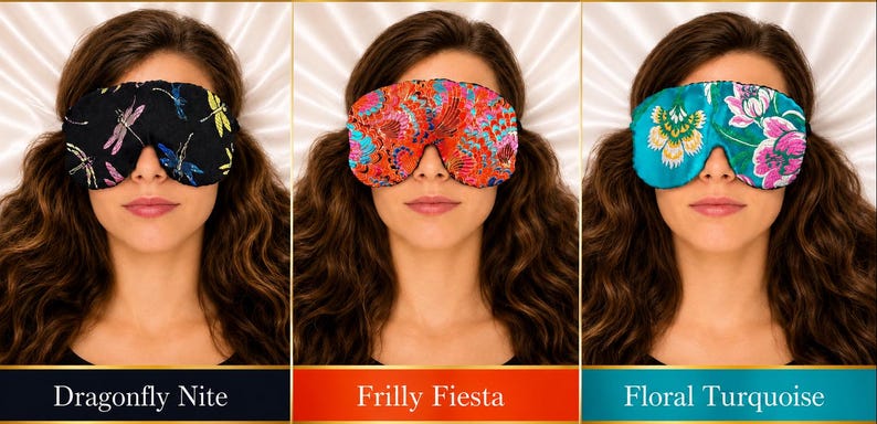 May include: Three sleep masks featuring distinct patterns: a black mask with dragonfly motifs labeled Dragonfly Nite, a vibrant red mask with intricate multi-colored floral designs labeled Frilly Fiesta, and a turquoise mask with large pink and white floral prints labeled Floral Turquoise.