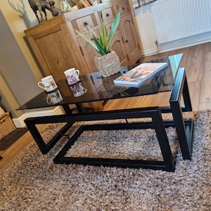 Black infinity coffee table with grey tint glass top