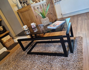 Black infinity coffee table with grey tint glass top