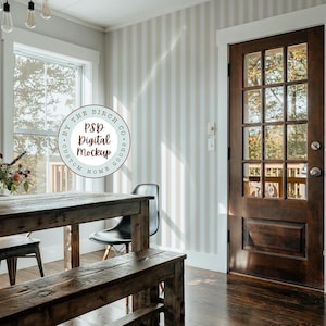 May include: A rustic wooden table and bench set in a room with a striped wallpaper and a wooden door. The table has a vase of flowers on it and a chair is pulled up to the table. The text "PSD Digital Mockup" is on a circle sticker.